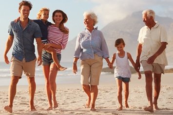 Multi-generational family walking together on a beach